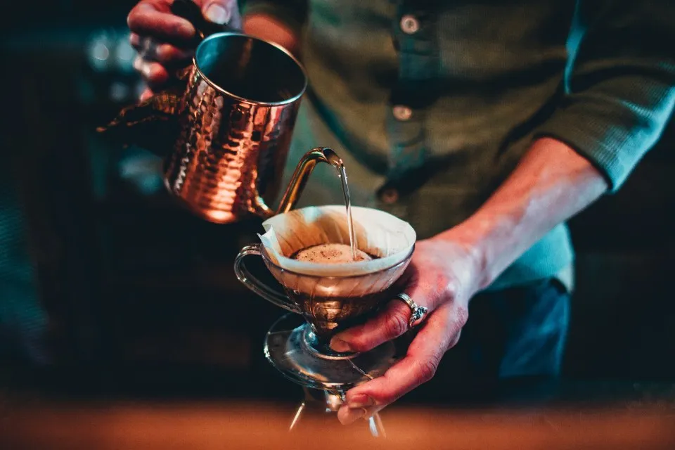 Barista pouring coffee